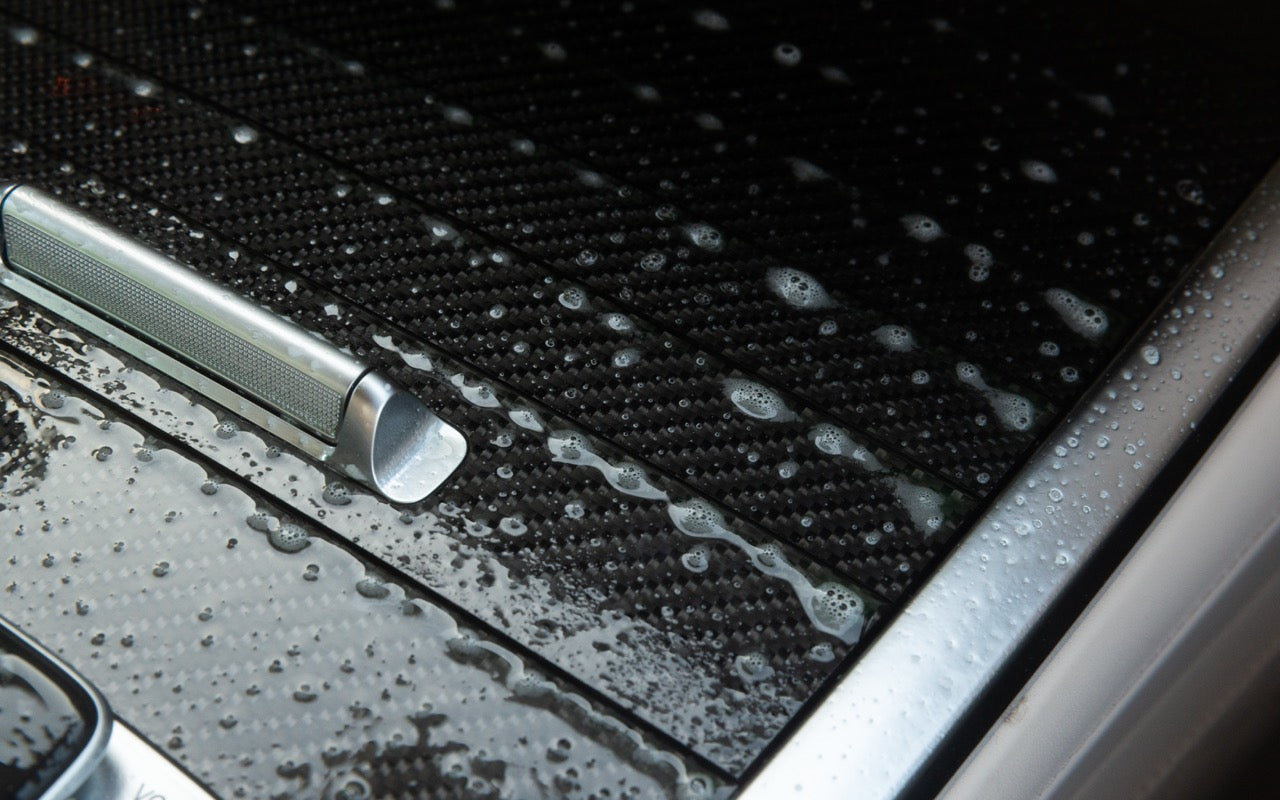 Car interior console trim being cleaned