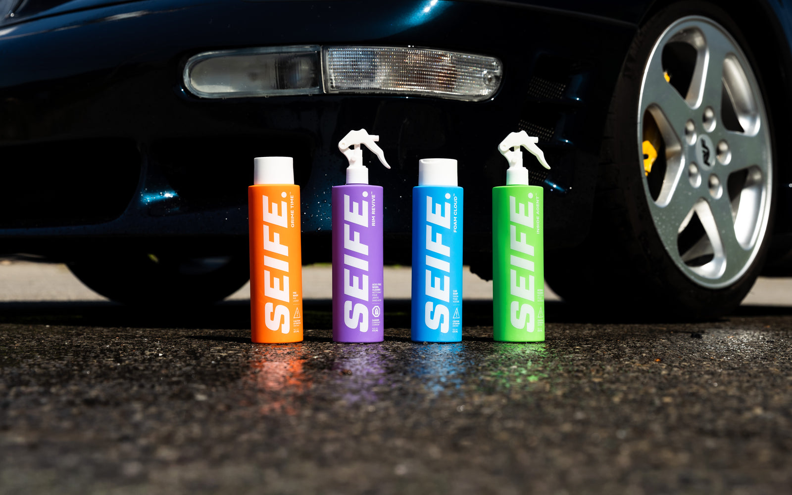 SEIFE Complete Wash System four bottles on pavement beside a dark sports car
